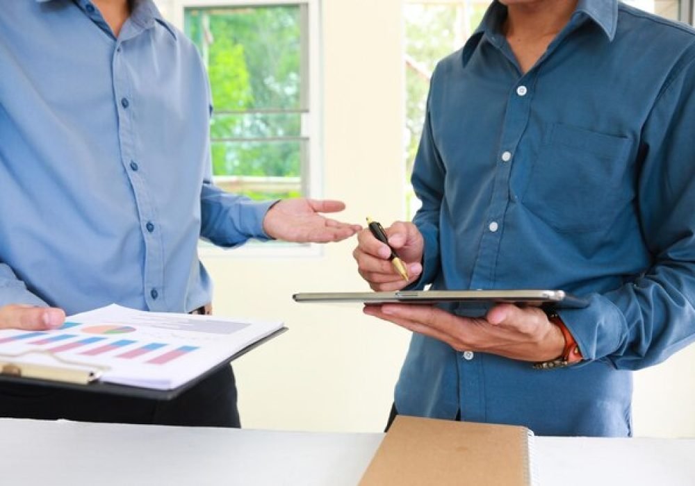 midsection-businessmen-discussing-office_38358-220